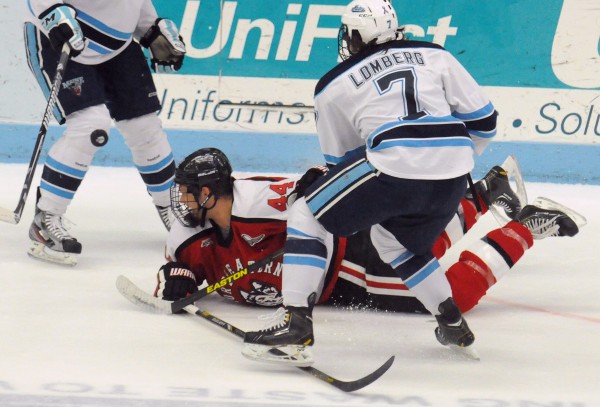 Northeastern's Dax Lauwers falls on the ice as he battles for the puck with the University of Maine's Ryan Lomberg during the second period of the Friday evening game in Orono. Northeastern's Dax Lauwers falls on the ice as he battles for the puck with the University of Maine's Ryan Lomberg during the second period of the Friday evening game in Orono.