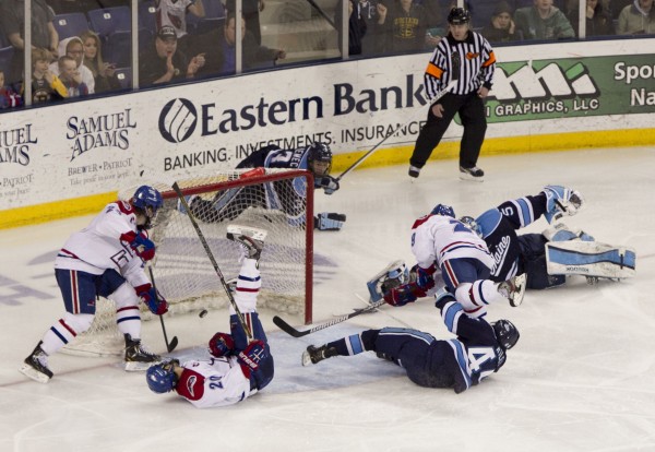 UMass Lowell's Derek Arnold (right) scores the winning goal in overtime against Maine Friday night, March 15, 2013, during the second game of their Hockey East quarterfinal playoff series. Maine players on the ice are Conor Riley (front), goalie Martin Ouellette and Mark Nemec. UMass Lowell's Derek Arnold (right) scores the winning goal in overtime against Maine Friday night, March 15, 2013, during the second game of their Hockey East quarterfinal playoff series. Maine players on the ice are Conor Riley (front), goalie Martin Ouellette and Mark Nemec.
