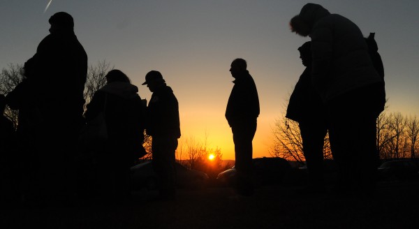 People stand listening to the church service held at the Thomas Hill Standpipe as the sun peaks over the horizon. The Columbia Street Baptist Church and members of other area Baptist churches participated in the service Easter Sunday morning. People stand listening to the church service held at the Thomas Hill Standpipe as the sun peaks over the horizon. The Columbia Street Baptist Church and members of other area Baptist churches participated in the service Easter Sunday morning.