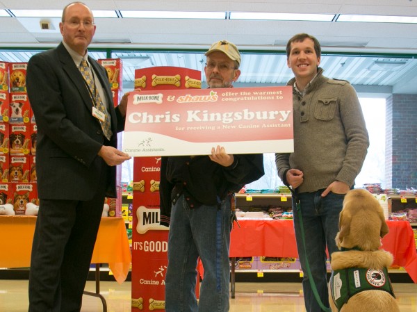 Shaw's store director Mark Robson (left) presents a large check to Chris Kingsbury (center) along with Canine Assistance trainer Kevin Balance (right) and his service dog representative, Henry, at the Shaw's supermarket on Main Street on Wednesday, March 13, 2013. Kingsburg will receive a donated assistance dog from Shaw's and Milk-bone sponsorship program. Shaw's store director Mark Robson (left) presents a large check to Chris Kingsbury (center) along with Canine Assistance trainer Kevin Balance (right) and his service dog representative, Henry, at the Shaw's supermarket on Main Street on Wednesday, March 13, 2013. Kingsburg will receive a donated assistance dog from Shaw's and Milk-bone sponsorship program.