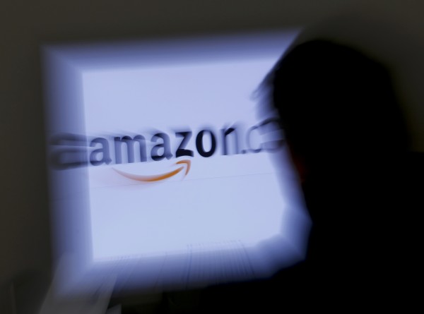 A zoomed illustration image of a man looking at a computer monitor showing the logo of Amazon is seen Nov. 26, 2012. A zoomed illustration image of a man looking at a computer monitor showing the logo of Amazon is seen Nov. 26, 2012.