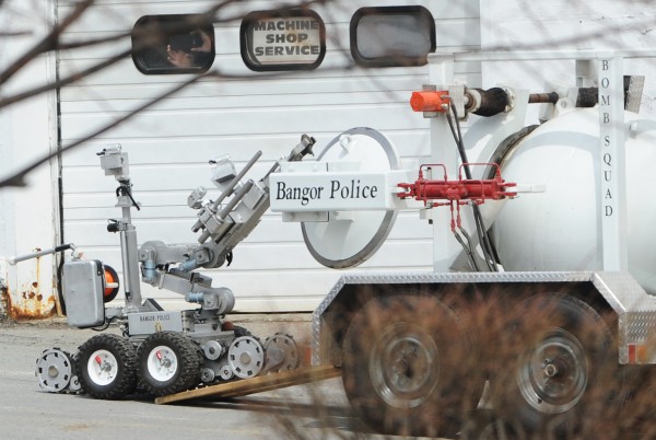 A Bangor police robot moves a hand grenade into a containment vessel on Davis Street in Bangor on Tuesday. Traffic on Main Street was stopped for five minutes as the robot performed its task. The grenade will be transported to the police department's disposal site, where it will be detonated using explosives. A Bangor police robot moves a hand grenade into a containment vessel on Davis Street in Bangor on Tuesday. Traffic on Main Street was stopped for five minutes as the robot performed its task. The grenade will be transported to the police department's disposal site, where it will be detonated using explosives.