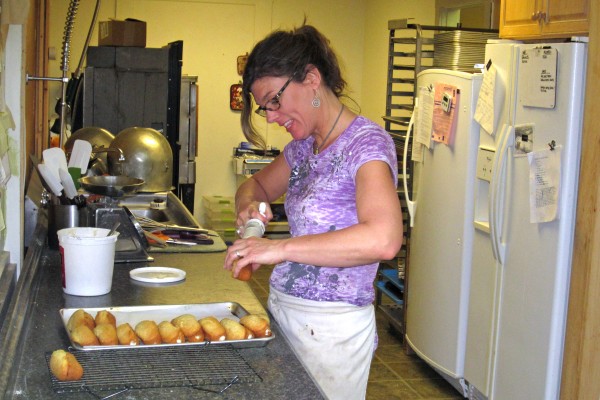 Kelley Hughes fills "twinkies" for her business, Wildflours Gluten-Free Market and Bakery. Hughes and four other businesses were destroyed in the April 17, 2011, fire at 45 Maine St. in Brunswick. Like the others, though, Hughes is back in business, waking at 3 a.m. some days to fill orders. Kelley Hughes fills "twinkies" for her business, Wildflours Gluten-Free Market and Bakery. Hughes and four other businesses were destroyed in the April 17, 2011, fire at 45 Maine St. in Brunswick. Like the others, though, Hughes is back in business, waking at 3 a.m. some days to fill orders.