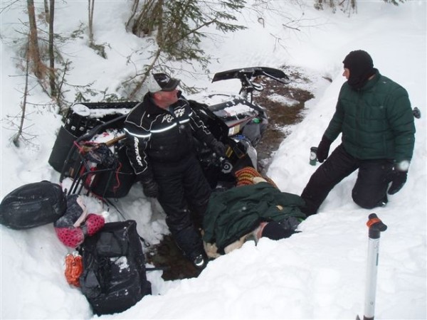 Phil Corriveau (left) of Fort Kent and Warden Adrian Marquis tend to Paul Lessard on Wednesday morning in St. John Plantation after the 64-year-old snowmobiler was found trapped under his overturned sled in a ditch just off the trail. Phil Corriveau (left) of Fort Kent and Warden Adrian Marquis tend to Paul Lessard on Wednesday morning in St. John Plantation after the 64-year-old snowmobiler was found trapped under his overturned sled in a ditch just off the trail.