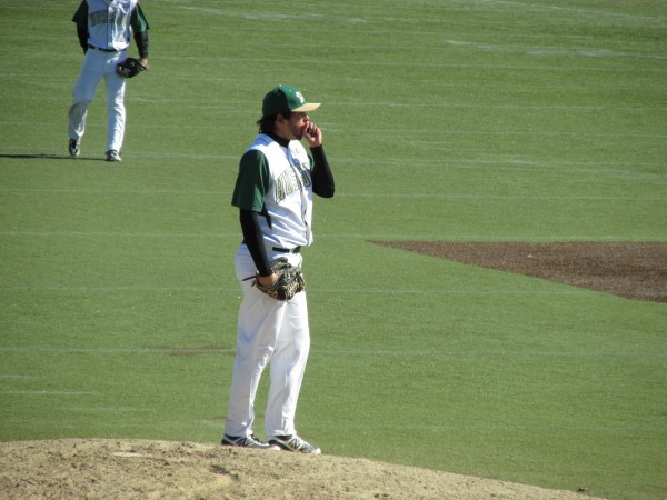 Husson University pitcher Zach Yates blows on his hand for warmth before delivering a pitch during Saturday's North Atlantic Conference baseball doubleheader at Winkin Complex in Bangor. Husson University pitcher Zach Yates blows on his hand for warmth before delivering a pitch during Saturday's North Atlantic Conference baseball doubleheader at Winkin Complex in Bangor.