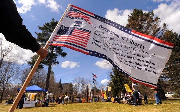Dana Lagassie of Vassalboro flies a Declaration of Liberty flag during a Patriots Day rally at Capitol Park in Augusta on Monday. Dana Lagassie of Vassalboro flies a Declaration of Liberty flag during a Patriots Day rally at Capitol Park in Augusta on Monday.