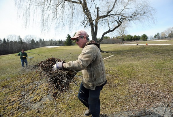 Robert Waugh and Robert Irwin (background), grounds crew, rake up sticks at Bangor Municipal Golf Course on Thursday in preparation for the start of the season. Robert Waugh and Robert Irwin (background), grounds crew, rake up sticks at Bangor Municipal Golf Course on Thursday in preparation for the start of the season.