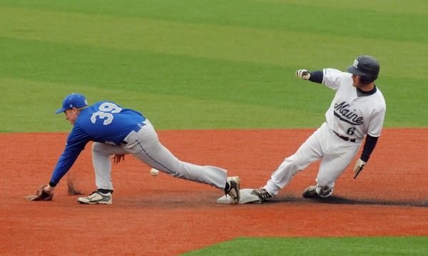 The University of Maine's Eric White (right) was safe at second base as Colby College's Benjamin Cocker could not make the catch. White went on to score on the play during the second inning of the game in Orono Tuesday. The University of Maine's Eric White (right) was safe at second base as Colby College's Benjamin Cocker could not make the catch. White went on to score on the play during the second inning of the game in Orono Tuesday.