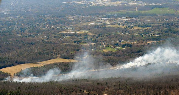 The Maine Forest Service and multiple municipal fire departments respond to a massive, fast-moving woods fire off College Street in Lewiston on Tuesday. The fire, reported at 1:15 p.m., was difficult to reach from the ground. The Maine Forest Service and multiple municipal fire departments respond to a massive, fast-moving woods fire off College Street in Lewiston on Tuesday. The fire, reported at 1:15 p.m., was difficult to reach from the ground.