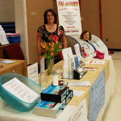 A vendor at the Healing Arts and Psychic Festival, Mary Johnson is demonstrating the Infrared Sauna to Beverly. A vendor at the Healing Arts and Psychic Festival, Mary Johnson is demonstrating the Infrared Sauna to Beverly.