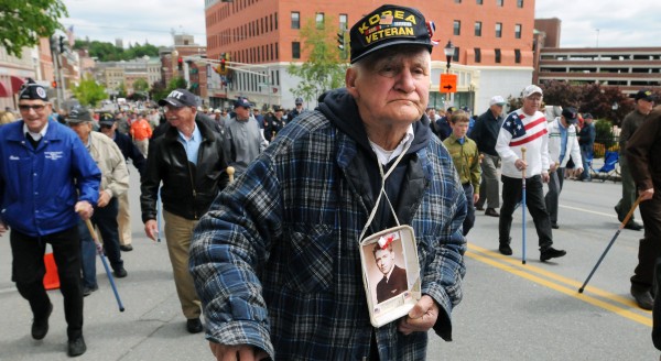 Korean War veteran Bernard Eaton of Amhurst holds a picture of his brother Kyle Eaton while marching in the Memorial Day parade in Bangor. The two brothers sevrved in the Navy during the Korean War, but Kyle Eaton, a pilot, was lost during a mission. "He is still there as far as I know," Bernard said. Korean War veteran Bernard Eaton of Amhurst holds a picture of his brother Kyle Eaton while marching in the Memorial Day parade in Bangor. The two brothers sevrved in the Navy during the Korean War, but Kyle Eaton, a pilot, was lost during a mission. "He is still there as far as I know," Bernard said.