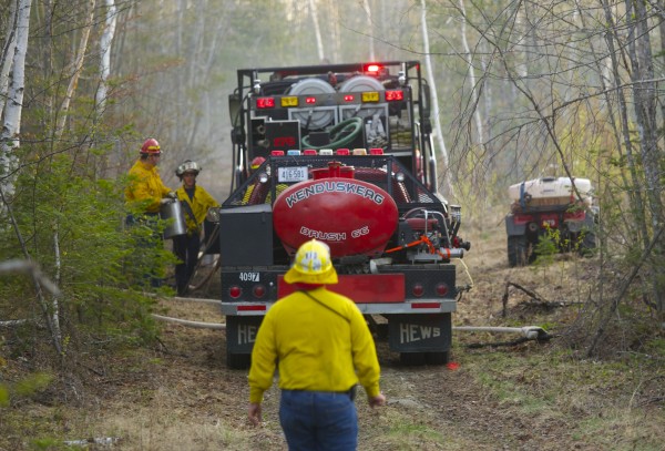 Fire crews fight a brush fire on a dirt road near the 2700 block of the Hudson Road in Hudson Monday evening. Fire crews fight a brush fire on a dirt road near the 2700 block of the Hudson Road in Hudson Monday evening.