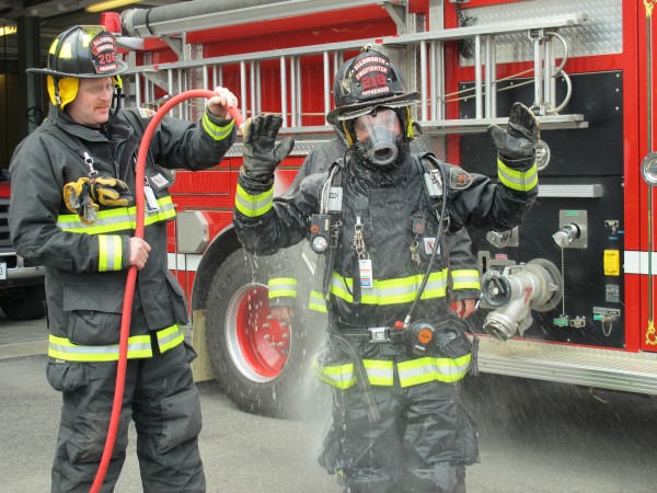 Ellsworth Fire Lt. Gary Saunders washes down a firefighter on Thursday, May 2, 2013, in a demonstration of how the department attempts to rid turnout gear of soot, smoke and dust that contain dangerous chemicals. Ellsworth Fire Lt. Gary Saunders washes down a firefighter on Thursday, May 2, 2013, in a demonstration of how the department attempts to rid turnout gear of soot, smoke and dust that contain dangerous chemicals.