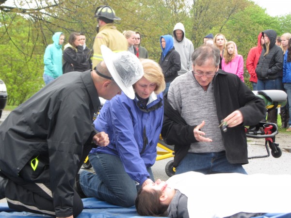 Dyann and Clyson Peters kneel over their daughter Shale Peters in the parking lot of Oceanside High School East in Rockland on Wednesday morning as part of the Every 15 Minutes program. The event that aims to make students aware of the dangers of drinking and driving. Knox County Sheriff's Office Chief Deputy Tim Carroll is kneeling with the parents. Dyann and Clyson Peters kneel over their daughter Shale Peters in the parking lot of Oceanside High School East in Rockland on Wednesday morning as part of the Every 15 Minutes program. The event that aims to make students aware of the dangers of drinking and driving. Knox County Sheriff's Office Chief Deputy Tim Carroll is kneeling with the parents.