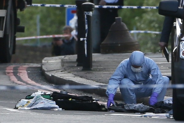 A police forensics officer investigates a crime scene where one man was killed in Woolwich, southeast London on Wednesday. British Prime Minister David Cameron has called a meeting of his government's emergency Cobra security committee after the killing of a man in south London. A police forensics officer investigates a crime scene where one man was killed in Woolwich, southeast London on Wednesday. British Prime Minister David Cameron has called a meeting of his government's emergency Cobra security committee after the killing of a man in south London.