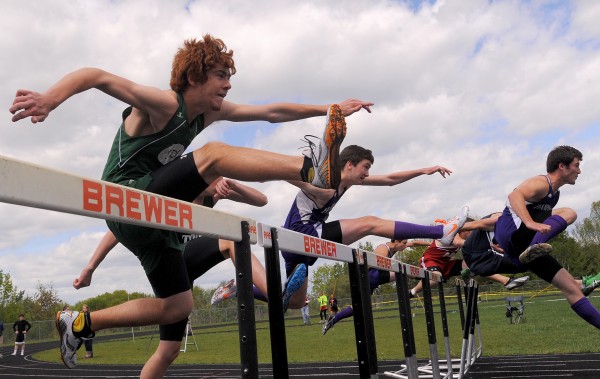 Competitors clear the first hurdles in the boy's 110 meter high hurdle semi-final race during the PVC Class B Track and Field Championship in Brewer Monday. Competitors clear the first hurdles in the boy's 110 meter high hurdle semi-final race during the PVC Class B Track and Field Championship in Brewer Monday.