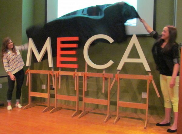 Maine College of Art students Sarah Mohammadi, left, and Hannah Sherwood pull the sheet off the school's new logo, created during a three-day intensive workshop by a team of MECA students, faculty and consultants. The unveiling took place during a Friday news conference at the Portland school. Maine College of Art students Sarah Mohammadi, left, and Hannah Sherwood pull the sheet off the school's new logo, created during a three-day intensive workshop by a team of MECA students, faculty and consultants. The unveiling took place during a Friday news conference at the Portland school.