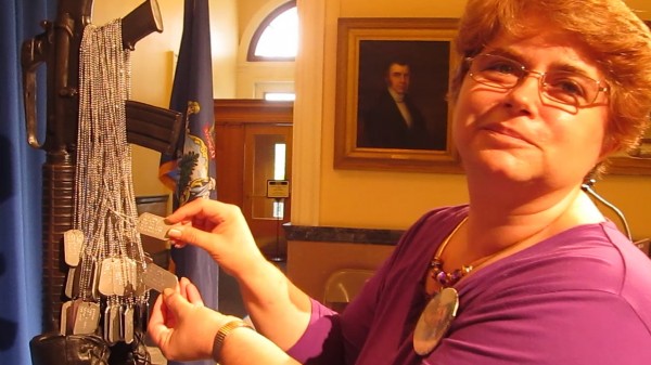 Cindy Small of Wiscasset displays some military dog tags that hang on the Maine Battlefield Cross Memorial at the State House on Friday, May 24, 2013. Army Private Andrew R. Small died in Afghanistan on August 11, 2006. Cindy Small of Wiscasset displays some military dog tags that hang on the Maine Battlefield Cross Memorial at the State House on Friday, May 24, 2013. Army Private Andrew R. Small died in Afghanistan on August 11, 2006.