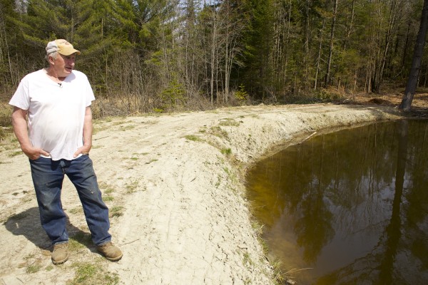 Richard Lary looks out over his trout pond Monday afternoon in Clinton. Lary, a dairy farmer has been told that he must remove the pond that he recently built on his property because it was built near a wetland and is flooding a nearby neighbors road. Lary has been threatened with fines up to $7,000 and $500 a day until the property is fixed from the Maine Department of Environment Protection. Richard Lary looks out over his trout pond Monday afternoon in Clinton. Lary, a dairy farmer has been told that he must remove the pond that he recently built on his property because it was built near a wetland and is flooding a nearby neighbors road. Lary has been threatened with fines up to $7,000 and $500 a day until the property is fixed from the Maine Department of Environment Protection.