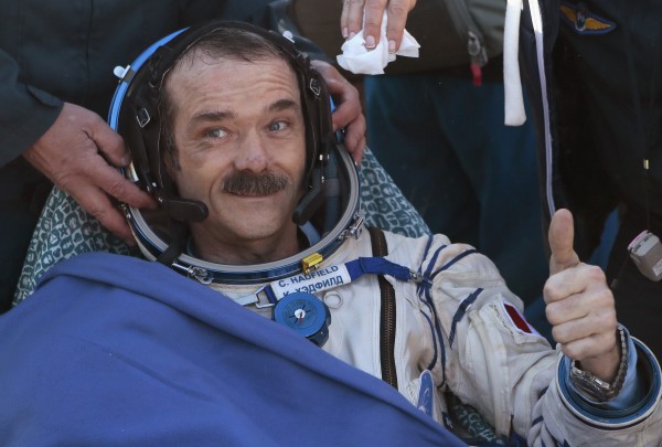 Canadian astronaut Chris Hadfield gestures with a thumbs up after the Russian Soyuz space capsule landed some 90 miles southeast of the town of Zhezkazgan, in central Kazakhstan May 14, 2013. Canadian astronaut Chris Hadfield gestures with a thumbs up after the Russian Soyuz space capsule landed some 90 miles southeast of the town of Zhezkazgan, in central Kazakhstan May 14, 2013.