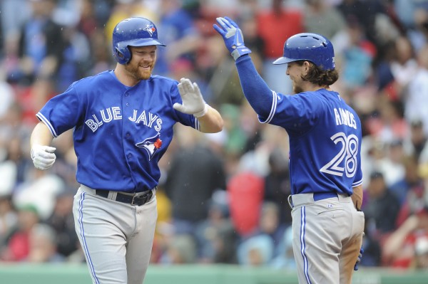 Toronto Blue Jays first baseman Adam Lind (26) is congratulated by center fielder Colby Rasmus (28) after hitting a home run during the ninth inning against the Boston Red Sox at Fenway Park. Toronto Blue Jays first baseman Adam Lind (26) is congratulated by center fielder Colby Rasmus (28) after hitting a home run during the ninth inning against the Boston Red Sox at Fenway Park.