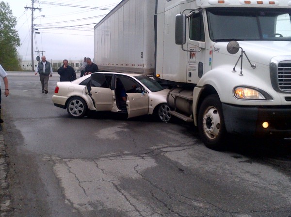 Dakota El-Hajj, 20, of Winterport remains in his car after a collision with a tractor-trailer on Mecaw Road in Hampden as emergency workers prepare to remove him from the vehicle Saturday. Dakota El-Hajj, 20, of Winterport remains in his car after a collision with a tractor-trailer on Mecaw Road in Hampden as emergency workers prepare to remove him from the vehicle Saturday.
