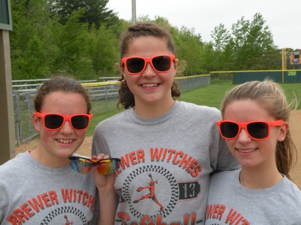 Meg Davis (left), Emily Gilmore (center) and Delaney Davis display sunglasses the Brewer High School softball team selected to wear this season. Coach Skip Estes decided there was too much variation in styles and he wanted them to be more uniform. The varsity and junior varsity players have a choice between the plastic-framed bright orange sunglasses these three are wearing and the sport sunglasses with a black-and-orange frame Meg Davis has in her left hand. Most of the varsity Witches wear the bright orange sunglasses while three wear the sport sunglasses. Meg Davis (left), Emily Gilmore (center) and Delaney Davis display sunglasses the Brewer High School softball team selected to wear this season. Coach Skip Estes decided there was too much variation in styles and he wanted them to be more uniform. The varsity and junior varsity players have a choice between the plastic-framed bright orange sunglasses these three are wearing and the sport sunglasses with a black-and-orange frame Meg Davis has in her left hand. Most of the varsity Witches wear the bright orange sunglasses while three wear the sport sunglasses.
