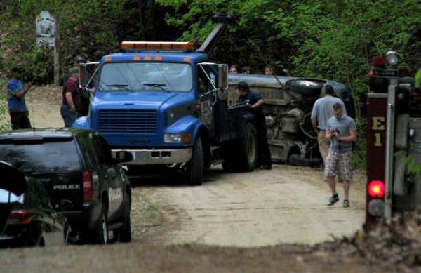 An M/T Pockets tow truck crewman retrieves a 1997 Subaru Legacy station wagon late Thursday afternoon from a drainage ditch along Thad White Road in Mexico. Its teen driver backed the car onto the dirt road's soft shoulder and the wagon flipped over and fell into the ditch, landing atop and pinning a teen who was riding on the roof, police at the scene said. An M/T Pockets tow truck crewman retrieves a 1997 Subaru Legacy station wagon late Thursday afternoon from a drainage ditch along Thad White Road in Mexico. Its teen driver backed the car onto the dirt road's soft shoulder and the wagon flipped over and fell into the ditch, landing atop and pinning a teen who was riding on the roof, police at the scene said.
