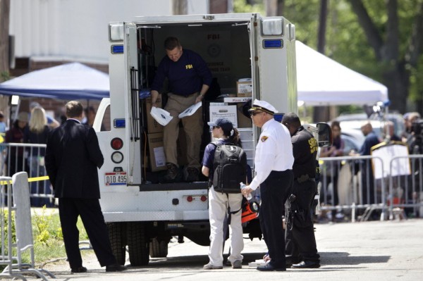 FBI agents and other law enforcement officers stand outside Ariel Castro's home in Cleveland, Ohio, May 9, 2013. Castro, a former school bus driver accused of kidnapping and raping three women during a decade of captivity in his house. FBI agents and other law enforcement officers stand outside Ariel Castro's home in Cleveland, Ohio, May 9, 2013. Castro, a former school bus driver accused of kidnapping and raping three women during a decade of captivity in his house.