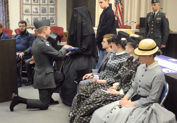 Bangor High School students reenacted the funeral of Civil War soldier Sgt. William P. Holden at the Bangor City Hall Friday. About 20 students participated in the reenactment from the theater class and members of the ROTC program performed the flag folding. Sgt. Holden was shot in the head and layed on the battlefield for about a week. He was eventually able to clean his wound some and later received help. He recovered to the point that he was able to walk, but died about nine months later due to fever. The reenactment was done in collaboration with the Bangor Museum and History Center. Nelson Durgin, Bangor City Council Chair, Major General, Maine Air National Guard (retired) provided closing remarks to the event. Bangor High School students reenacted the funeral of Civil War soldier Sgt. William P. Holden at the Bangor City Hall Friday. About 20 students participated in the reenactment from the theater class and members of the ROTC program performed the flag folding. Sgt. Holden was shot in the head and layed on the battlefield for about a week. He was eventually able to clean his wound some and later received help. He recovered to the point that he was able to walk, but died about nine months later due to fever. The reenactment was done in collaboration with the Bangor Museum and History Center. Nelson Durgin, Bangor City Council Chair, Major General, Maine Air National Guard (retired) provided closing remarks to the event.