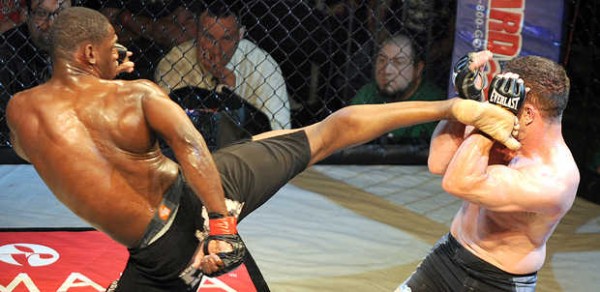 Marcus Davis, from Team Irish, right, blocks a kick from Darrius Heyliger of Bombsquad during Saturday's MMA Cagefight at the Androscoggin Bank Colisee in Lewiston. Davis won in a decision. Marcus Davis, from Team Irish, right, blocks a kick from Darrius Heyliger of Bombsquad during Saturday's MMA Cagefight at the Androscoggin Bank Colisee in Lewiston. Davis won in a decision.