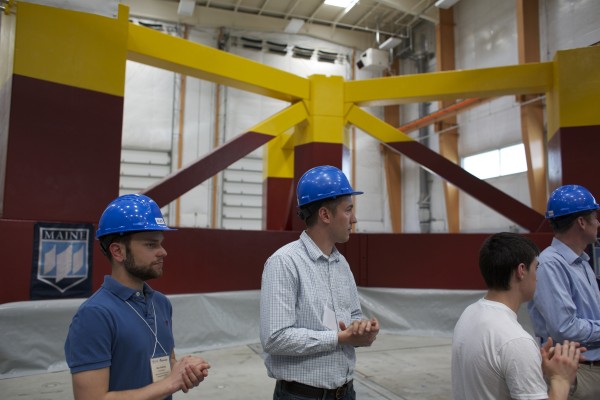 From left, Alex Coulling, a University of Maine, Orono civil engineering graduate student, and UMaine research engineer Josh Clapp stand in front of the newly unveiled base for a floating wind turbine which will be shipped down the Penobscot River and out to the Gulf of Maine where it will become the first floating wind turbine off the coast of the U.S. From left, Alex Coulling, a University of Maine, Orono civil engineering graduate student, and UMaine research engineer Josh Clapp stand in front of the newly unveiled base for a floating wind turbine which will be shipped down the Penobscot River and out to the Gulf of Maine where it will become the first floating wind turbine off the coast of the U.S.