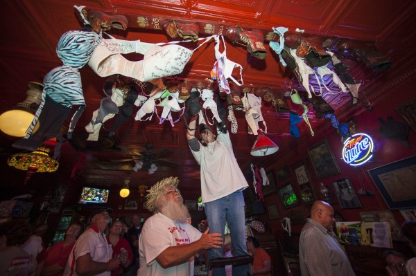 A patron of the Holler House bar participates in the Great Bra Rehanging event in Milwaukee, Wisconsin June 14, 2013. A Milwaukee city inspector had in April ordered Holler House's owner Marcy Skowronski to take down the bras, which have been hanging in the bar for the last 45 years as tradition, saying they were a fire hazard, but has since backed out of the order. A patron of the Holler House bar participates in the Great Bra Rehanging event in Milwaukee, Wisconsin June 14, 2013. A Milwaukee city inspector had in April ordered Holler House's owner Marcy Skowronski to take down the bras, which have been hanging in the bar for the last 45 years as tradition, saying they were a fire hazard, but has since backed out of the order.
