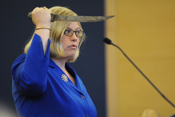 Assistant District Attorney Alice Clifford demonstrates to the jury, during opening arguments on Monday at the Penobscot Judicial Center in Bangor, how the prosecution claims Warren Dome threatened state police with a knife on August 14, 2012, at his home in Edinburg. Assistant District Attorney Alice Clifford demonstrates to the jury, during opening arguments on Monday at the Penobscot Judicial Center in Bangor, how the prosecution claims Warren Dome threatened state police with a knife on August 14, 2012, at his home in Edinburg.