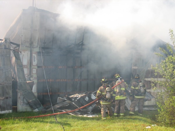 Firefighters spray water inside a smoldering shell of a storage rental unit building on Route 172 in Sedgwick on Saturday, June 1, 2013. Firefighters spray water inside a smoldering shell of a storage rental unit building on Route 172 in Sedgwick on Saturday, June 1, 2013.