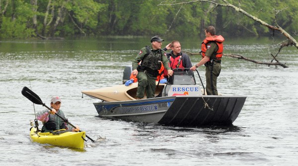 Orono rescue personnel and game wardens bring a kayak belonging to Melissa McLaughlin back to shore after rescuing the Brewer resident from Pushaw Stream on Wednesday. Orono rescue personnel and game wardens bring a kayak belonging to Melissa McLaughlin back to shore after rescuing the Brewer resident from Pushaw Stream on Wednesday.