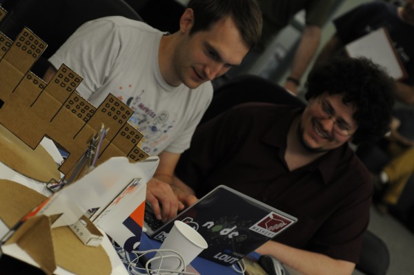 Garrett Wilkin, left, organizer of the Bangor branch of the National Day of Civic Hacking, and Kyle Frick of Eddington celebrate a success while building an exhibit for the Maine Discovery Museum that can be controlled over the Internet. Garrett Wilkin, left, organizer of the Bangor branch of the National Day of Civic Hacking, and Kyle Frick of Eddington celebrate a success while building an exhibit for the Maine Discovery Museum that can be controlled over the Internet.