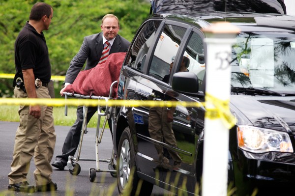 Officials on the scene remove one of two bodies from 53 Durham Road in Freeport Tuesday. Officials on the scene remove one of two bodies from 53 Durham Road in Freeport Tuesday.