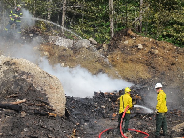 Firefighters from Dedham and Ellsworth work to knock down a brush fire that had gotten out of control at a construction company site in Dedham on Tuesday. Firefighters from Dedham and Ellsworth work to knock down a brush fire that had gotten out of control at a construction company site in Dedham on Tuesday.