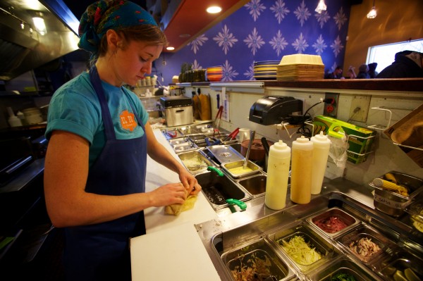 Casey Turner of El Rayo Taqueria in Portland makes a $5 burrito during a snowstorm Wednesday, Jan. 16, 2013. The Mexican eatery offers the $5 burrito special whenever the city calls a parking ban. Casey Turner of El Rayo Taqueria in Portland makes a $5 burrito during a snowstorm Wednesday, Jan. 16, 2013. The Mexican eatery offers the $5 burrito special whenever the city calls a parking ban.