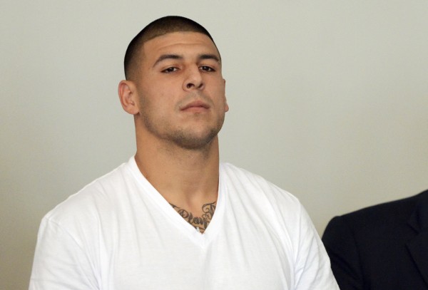 Former New England Patriots tight end Aaron Hernandez is arraigned on charges of murder and weapons violations in Attleborough, Massachusetts, after being arrested, June 26, 2013. Former New England Patriots tight end Aaron Hernandez is arraigned on charges of murder and weapons violations in Attleborough, Massachusetts, after being arrested, June 26, 2013.