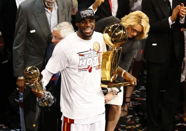 Miami Heat small forward LeBron James celebrates with the Larry O'Brien Championship trophy and the MVP trophy after Game 7 in the NBA Finals at American Airlines Arena. Miami defeated San Antonio 95-88 to win the title Thursday night. Miami Heat small forward LeBron James celebrates with the Larry O'Brien Championship trophy and the MVP trophy after Game 7 in the NBA Finals at American Airlines Arena. Miami defeated San Antonio 95-88 to win the title Thursday night.