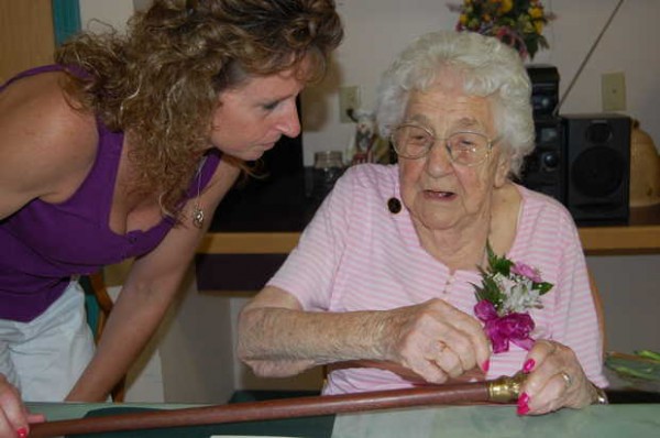 Anne-Marie Veilleux, 99, looks over the replica of the Boston Post Cane she was presented with by Jay town officials on Monday for being the oldest citizen in Jay. Veilleux's grandson, Rick Howatt's girlfriend, Michelle Leavitt, left, talks with Veilleux about the cane. Anne-Marie Veilleux, 99, looks over the replica of the Boston Post Cane she was presented with by Jay town officials on Monday for being the oldest citizen in Jay. Veilleux's grandson, Rick Howatt's girlfriend, Michelle Leavitt, left, talks with Veilleux about the cane.