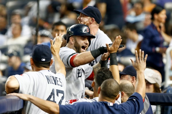 Boston Red Sox first baseman Mike Napoli (center) celebrates a grand slam with teammates in the dugout against the New York Yankees during the third inning Saturday Night at Yankee Stadium. Boston Red Sox first baseman Mike Napoli (center) celebrates a grand slam with teammates in the dugout against the New York Yankees during the third inning Saturday Night at Yankee Stadium.