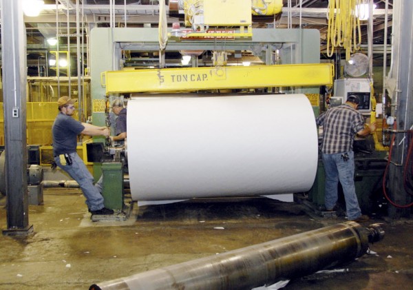 Workers at Lincoln Paper and Tissue LLC of Lincoln move a giant roll of paper onto a machine at the mill on March 11, 2011. Workers at Lincoln Paper and Tissue LLC of Lincoln move a giant roll of paper onto a machine at the mill on March 11, 2011.
