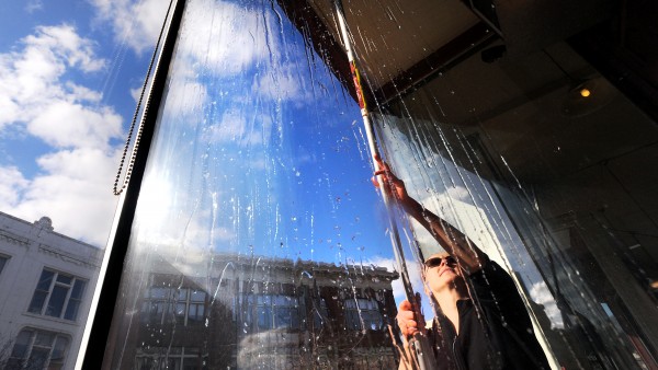 Sonya Eldridge, owner of Bagel Central in Bangor, washes the windows of her business on a Tuesday afternoon in February. Sonya Eldridge, owner of Bagel Central in Bangor, washes the windows of her business on a Tuesday afternoon in February.