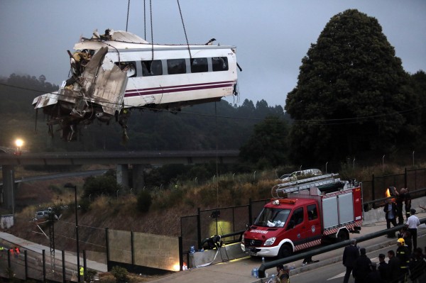 A crane removes a carriage from the tracks at the site of a train crash near Santiago de Compostela, northwestern Spain, July 25, 2013. A train derailed outside the ancient northwestern Spanish city of Santiago de Compostela on Wednesday evening, killing at least 77 people and injuring up to 131 in one of Europe's worst rail disasters. A crane removes a carriage from the tracks at the site of a train crash near Santiago de Compostela, northwestern Spain, July 25, 2013. A train derailed outside the ancient northwestern Spanish city of Santiago de Compostela on Wednesday evening, killing at least 77 people and injuring up to 131 in one of Europe's worst rail disasters.