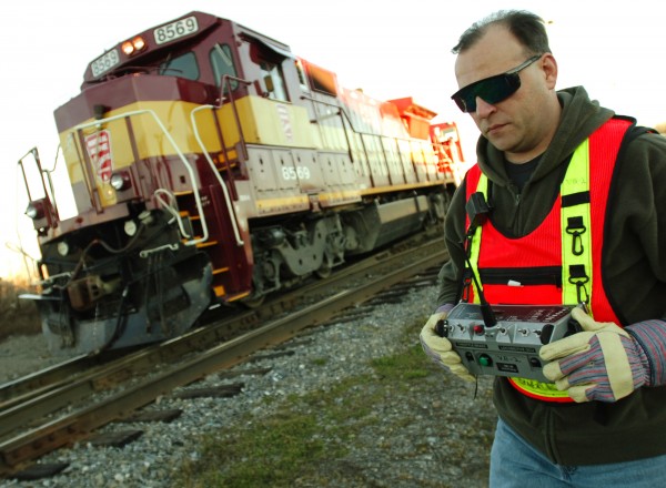 Montreal, Maine & Atlantic Railway engineer Chuck Gould uses a remote control transmitter to move a locomotive at the railway's switching yard in Hermon. Montreal, Maine & Atlantic Railway engineer Chuck Gould uses a remote control transmitter to move a locomotive at the railway's switching yard in Hermon.