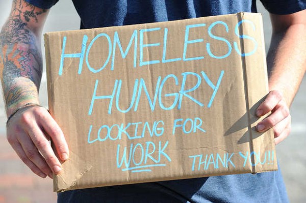A panhandler on State Street holds a handmade sign in Portland recently. A panhandler on State Street holds a handmade sign in Portland recently.