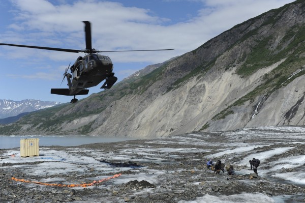 Members of a specialized investigative team from the Joint POW/MIA Accounting Command wait as a UH-60 Blackhawk helicopter comes in for a landing to transport them back to base after a day of assessing a historic aircraft crash site at Colony Glacier, Alaska, in this June 24, 2013 handout photo released to Reuters on July 8, 2013. An Alaska glacier is exposing remains from a military air tragedy six decades later. Relics from an Air Force cargo plane that slammed into a mountain in November 1952, killing all 52 servicemen on board, first emerged last summer on Colony Glacier, about 50 miles east of Anchorage. Members of a specialized investigative team from the Joint POW/MIA Accounting Command wait as a UH-60 Blackhawk helicopter comes in for a landing to transport them back to base after a day of assessing a historic aircraft crash site at Colony Glacier, Alaska, in this June 24, 2013 handout photo released to Reuters on July 8, 2013. An Alaska glacier is exposing remains from a military air tragedy six decades later. Relics from an Air Force cargo plane that slammed into a mountain in November 1952, killing all 52 servicemen on board, first emerged last summer on Colony Glacier, about 50 miles east of Anchorage.